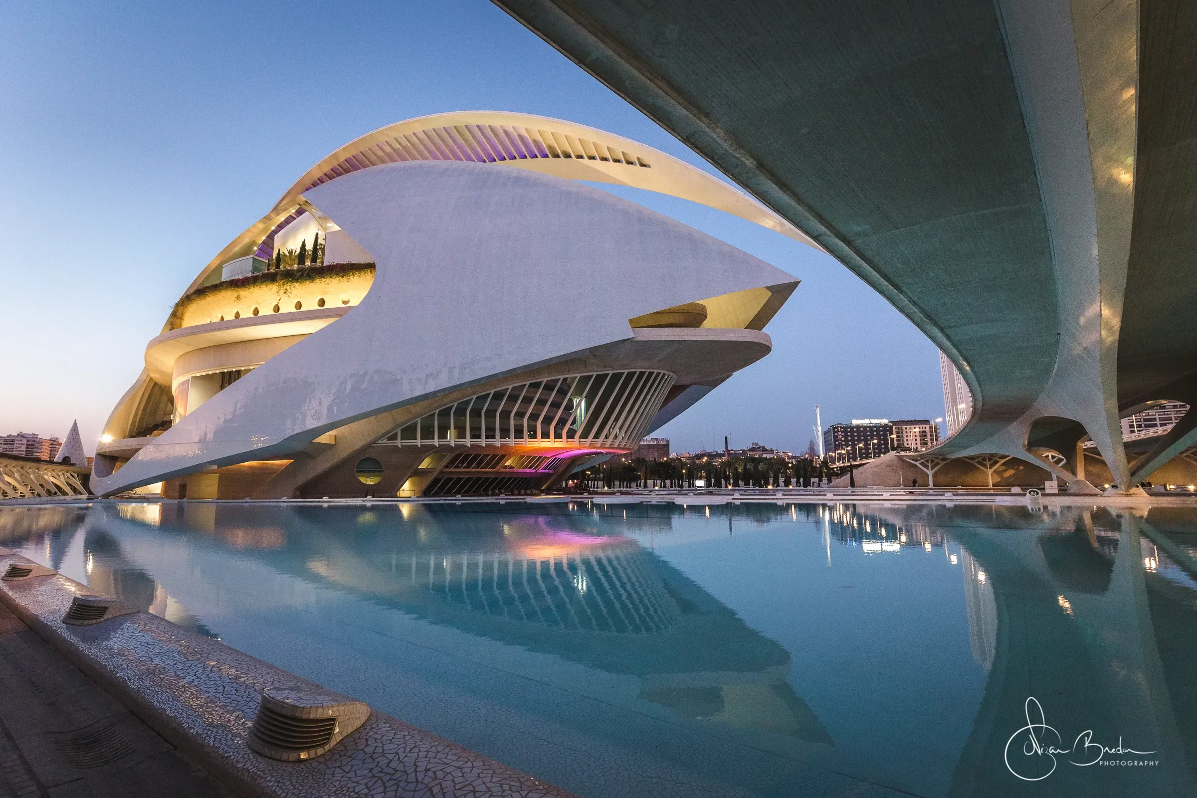 White sculptural forms and their reflection along the water