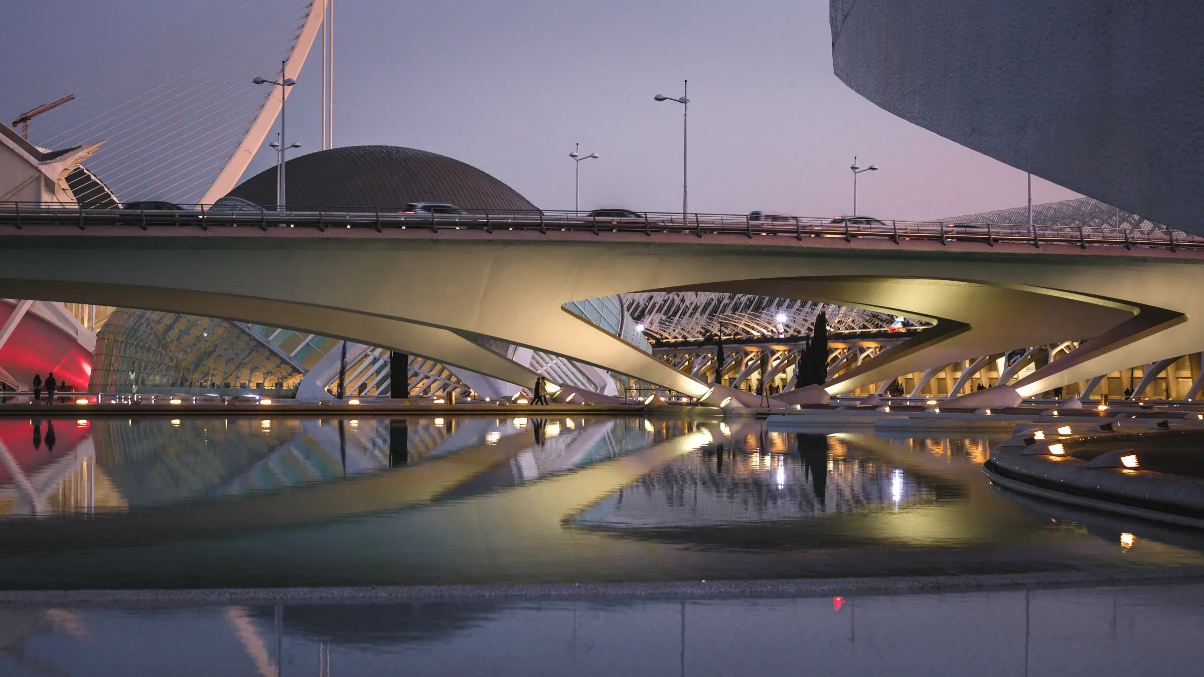 Layered white bridges and domes reflected in water at blue hour